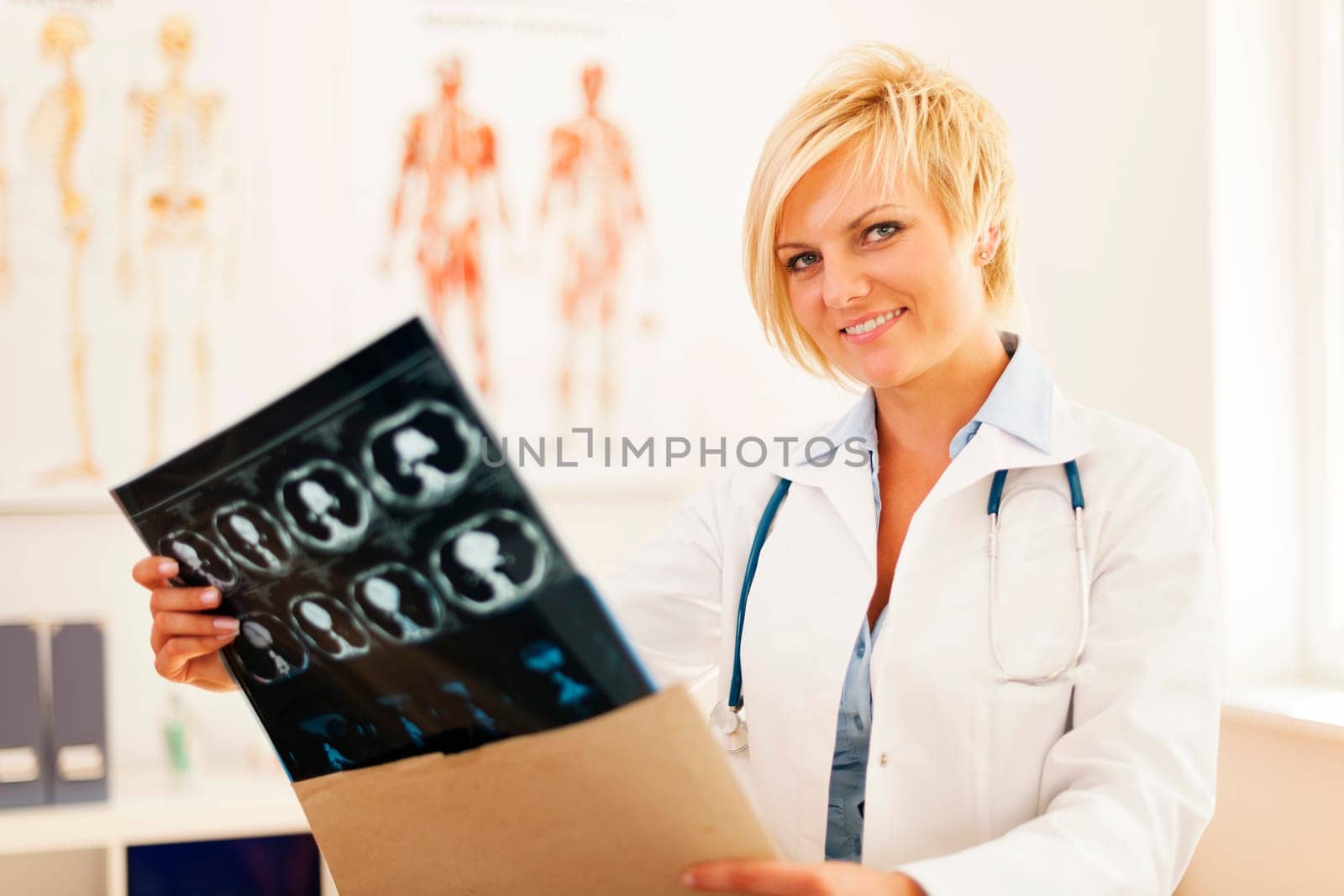 Young female doctor opening envelope with brain tomography result