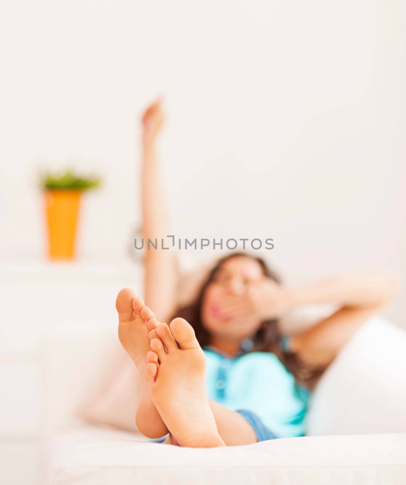 Young woman stretching after nap