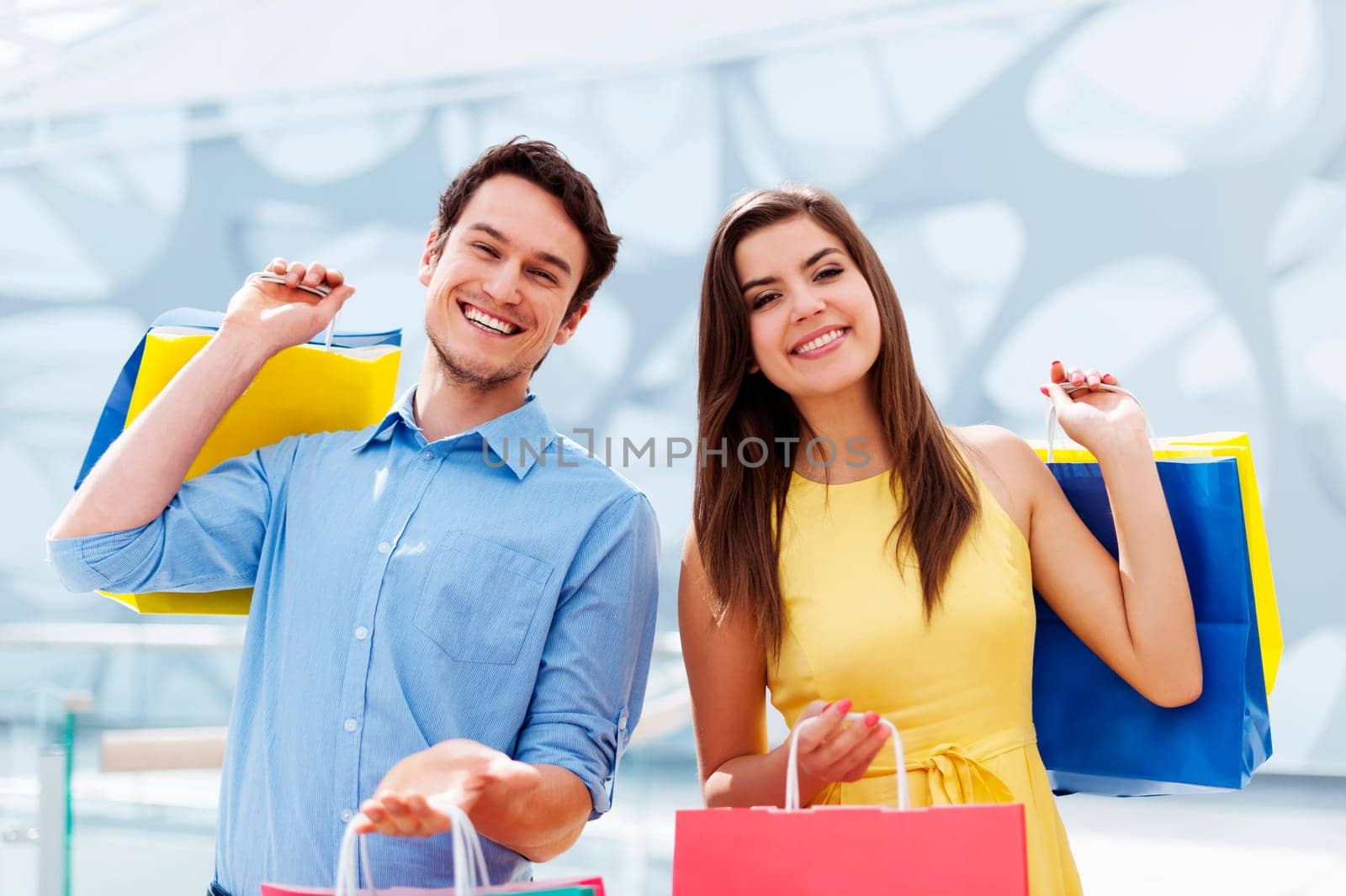 Happy young couple holding shopping bag
