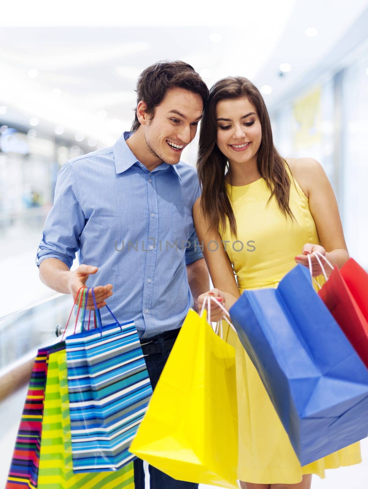 Surprised man peeking into shopping bag