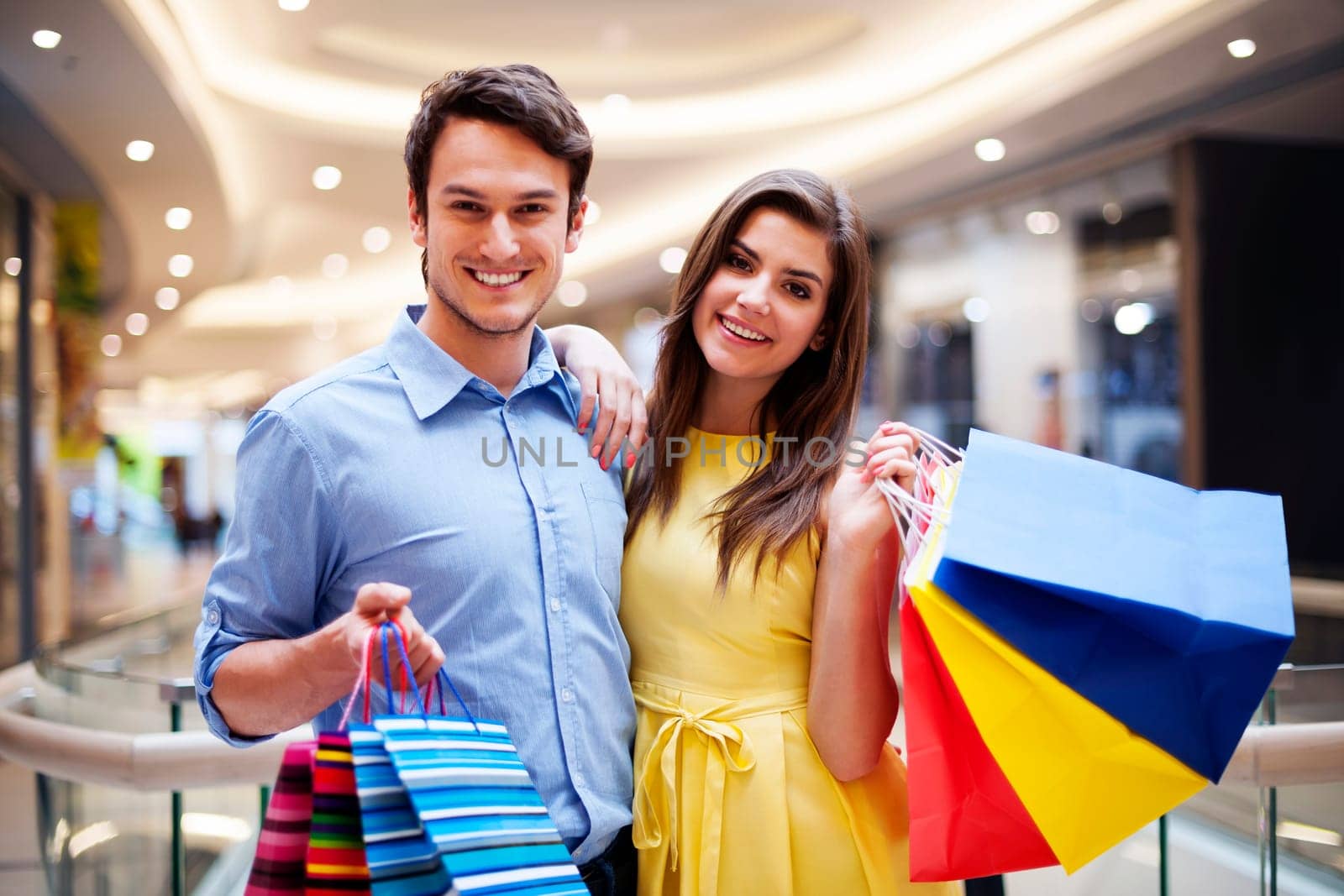 Portrait of happy couple with shopping bags