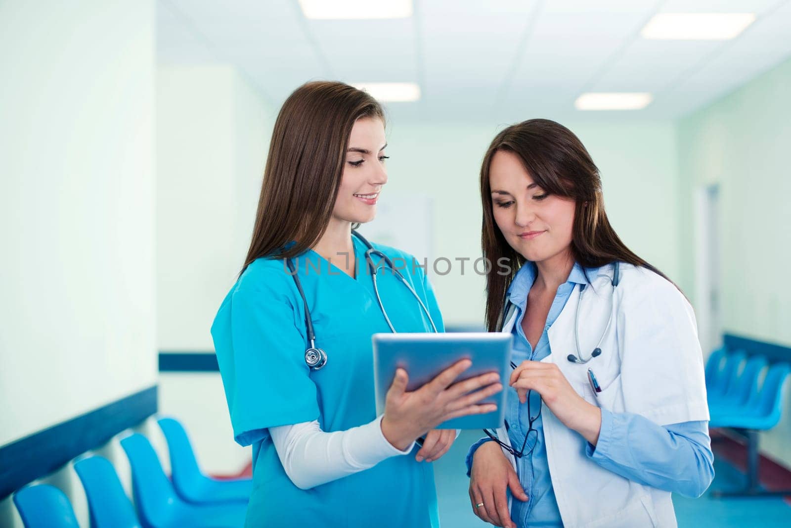Female doctors checking results on digital tablet