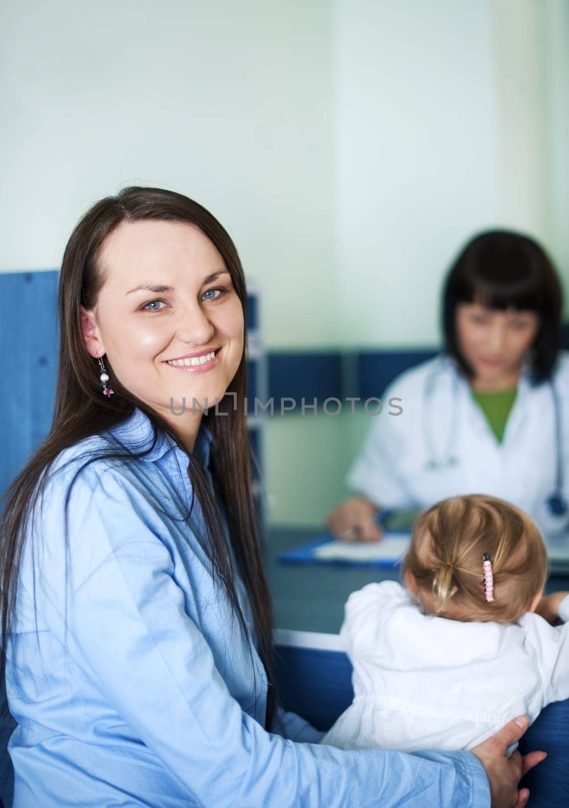 Smiling mother with her child at doctors office