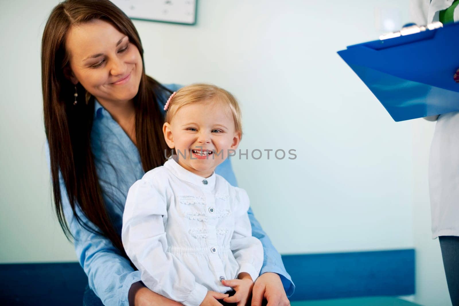 Laughing baby and mother at doctors office
