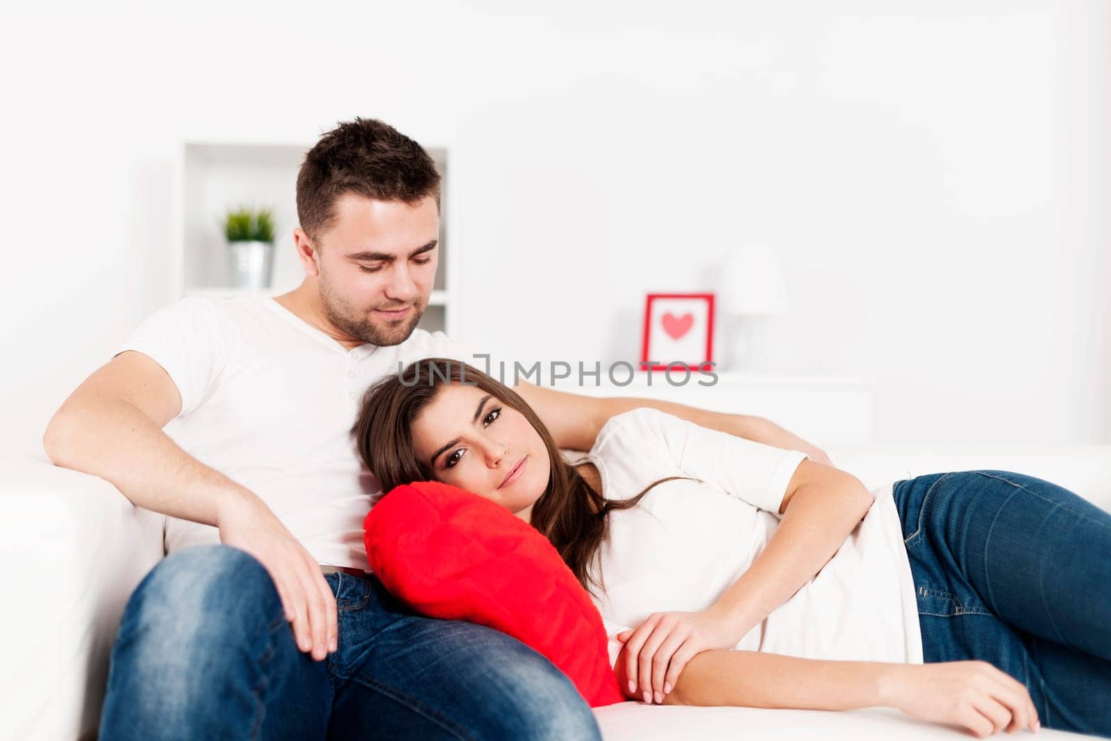 Loving couple resting on couch