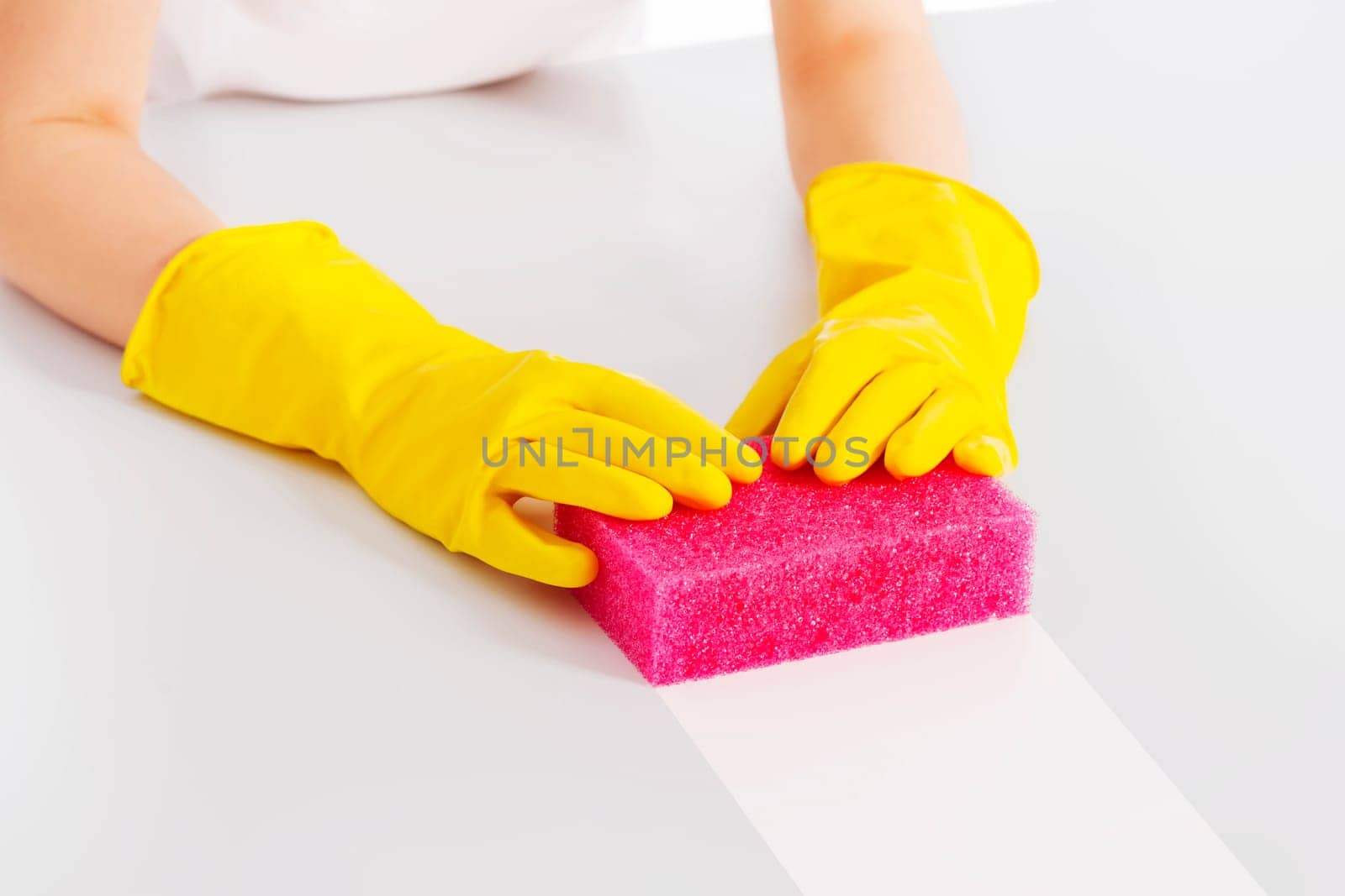 Cleaning table with pink sponge and protective glove