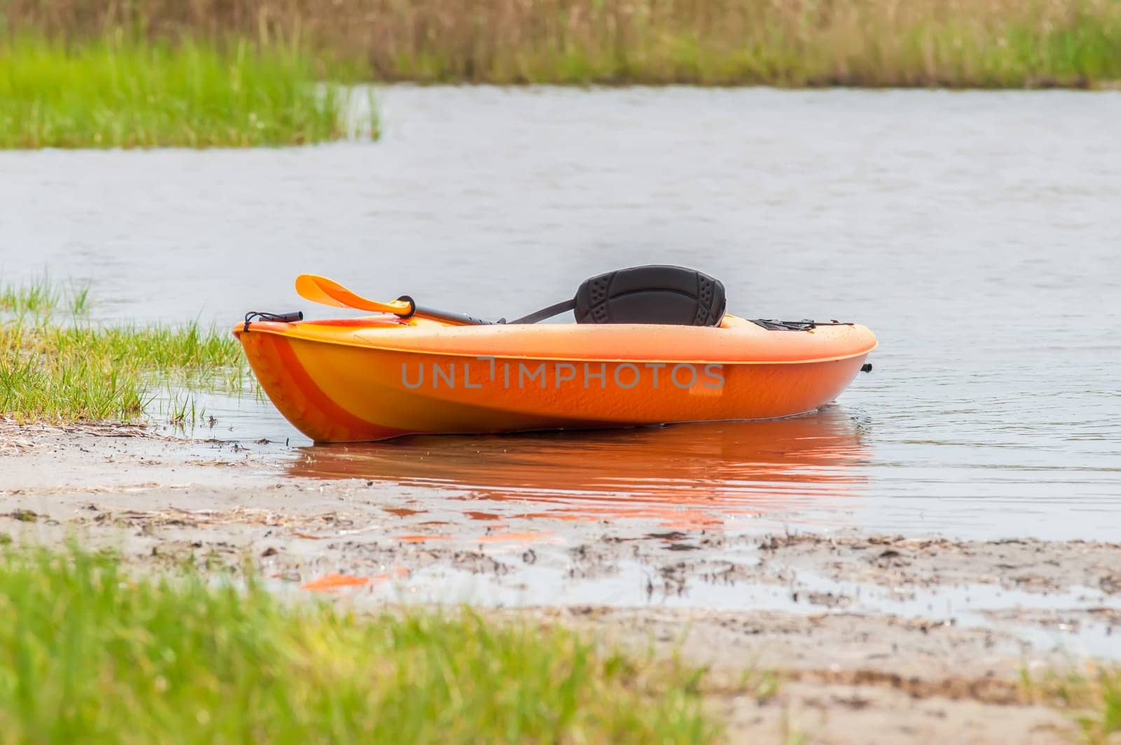 orange kayak on pamlino sound beach in north carolina