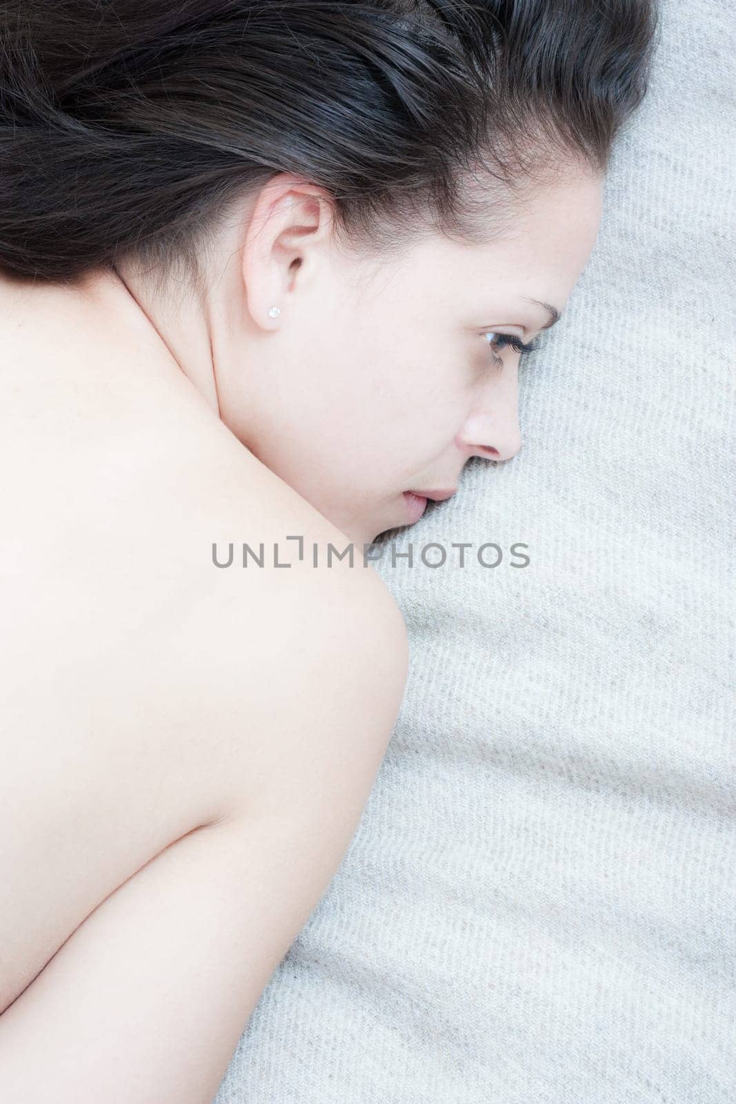 Serene young woman lying on a bed