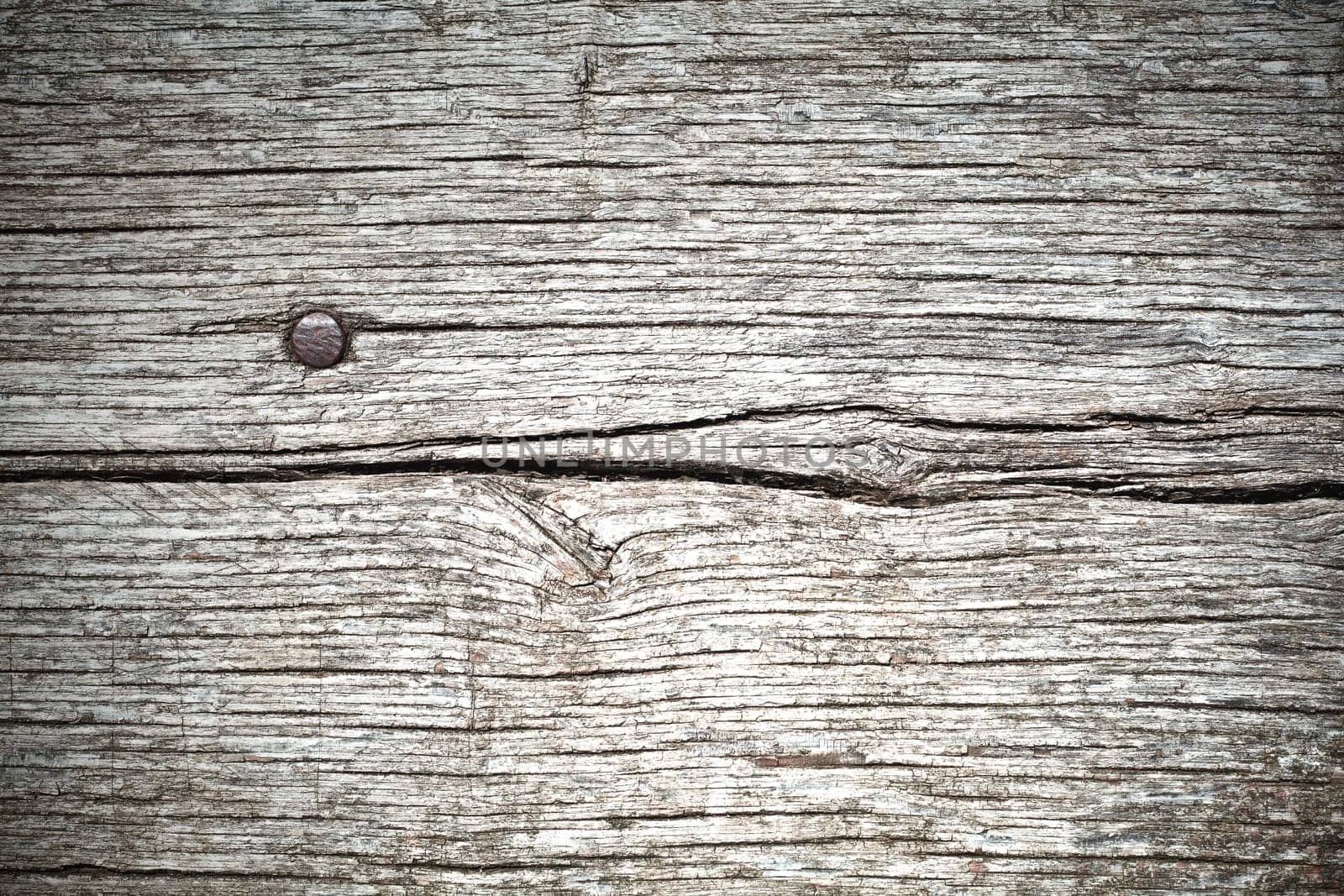 Background composed of planks of old wood and a nail