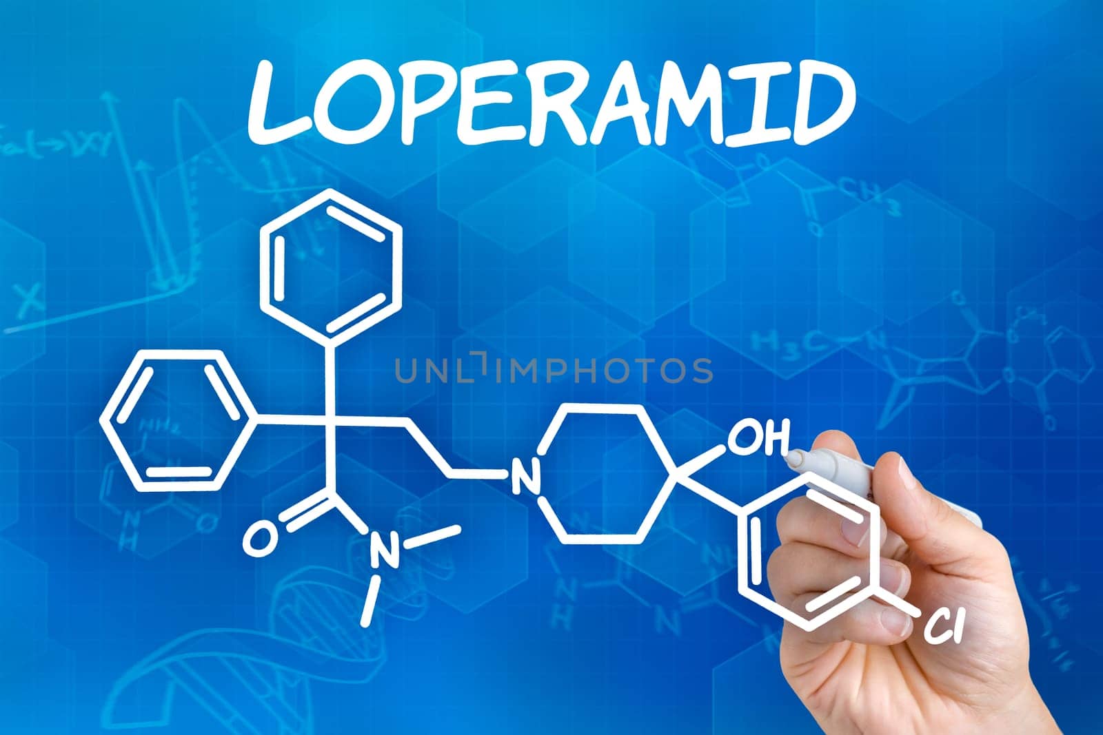 Hand with pen draws chemical structural formula of loperamide
