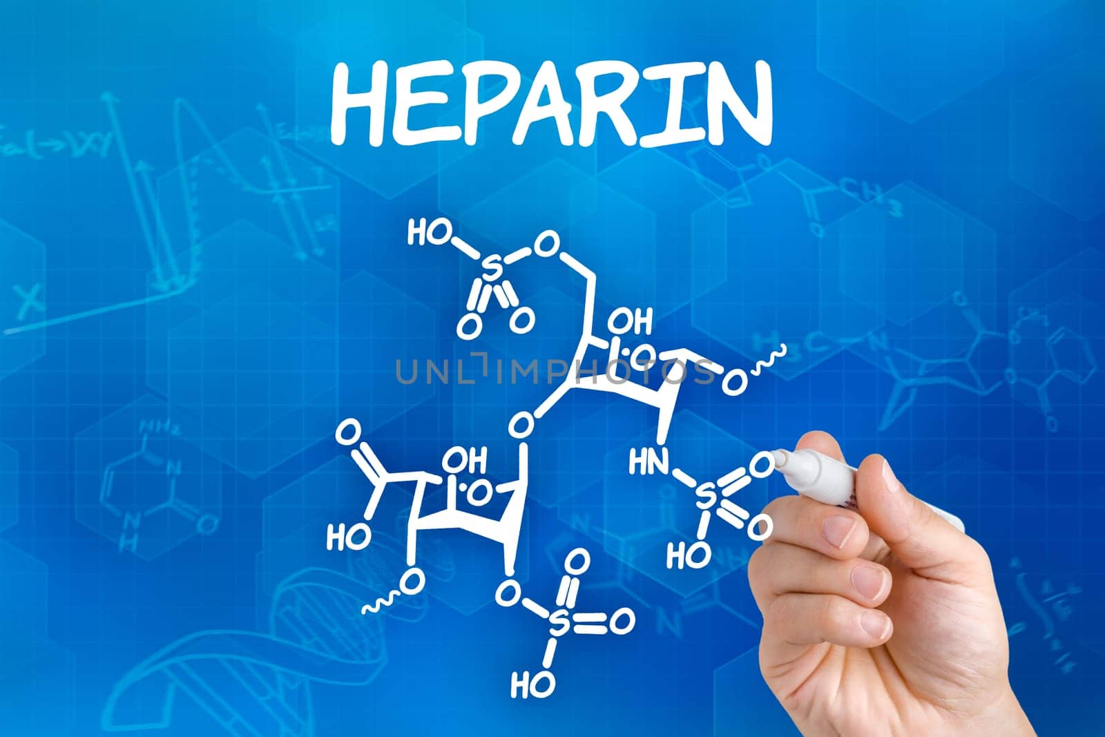 Hand with pen draws chemical structural formula of heparin