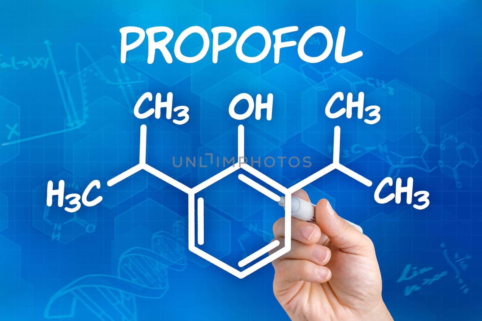 Hand with pen draws chemical structural formula of Propofol