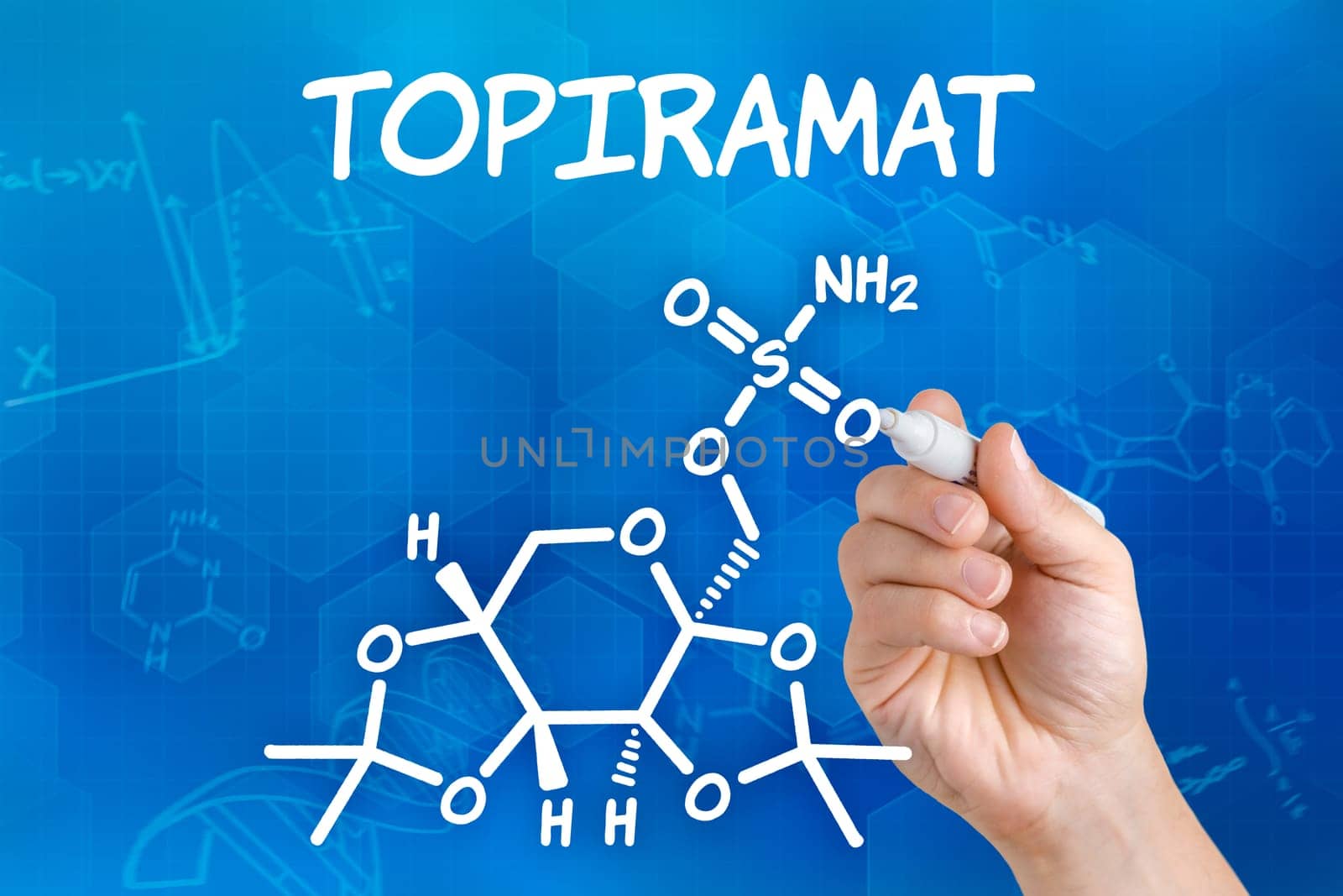 Hand with pen draws chemical structural formula of topiramate