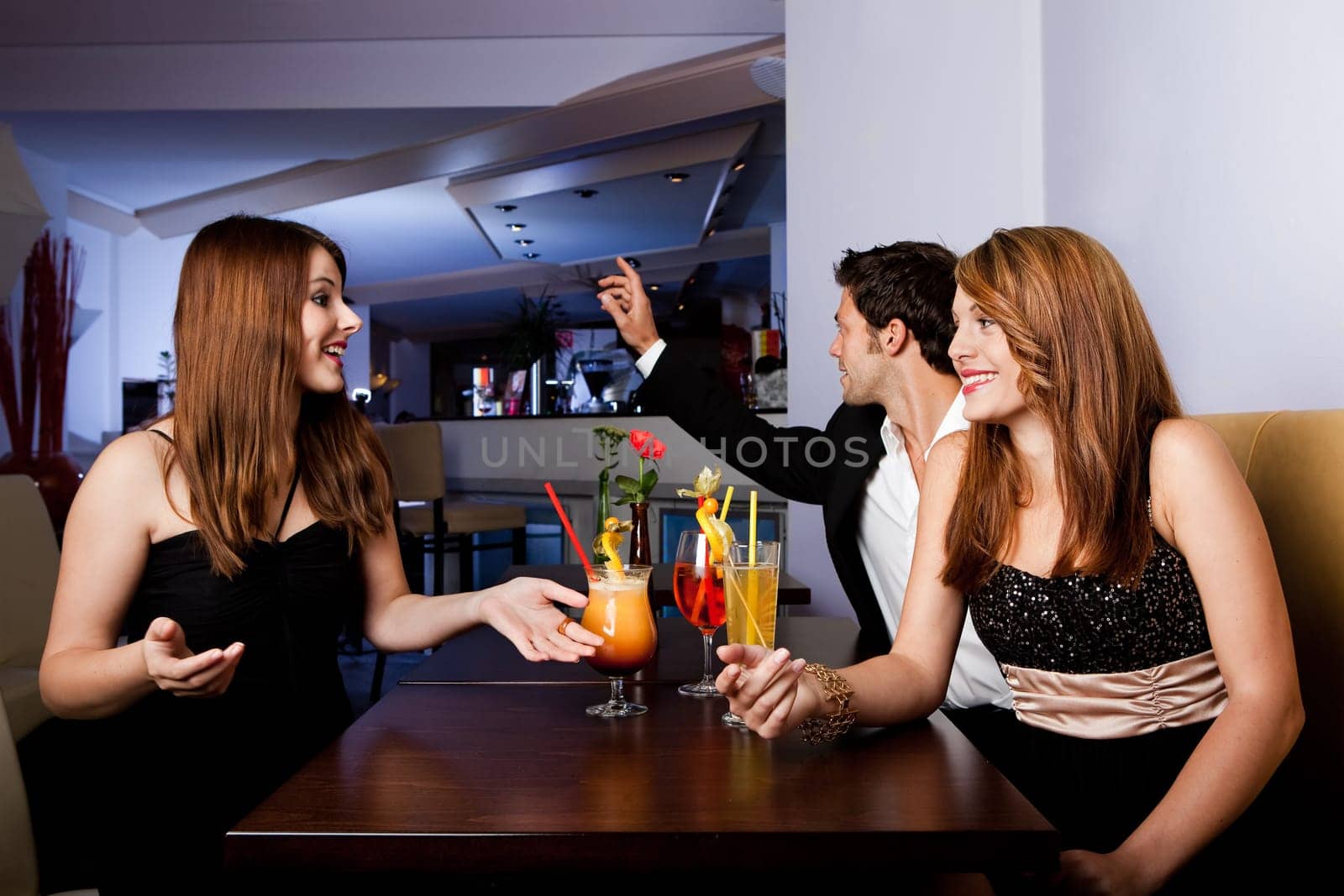 Man ordering drinks while girls having fun
