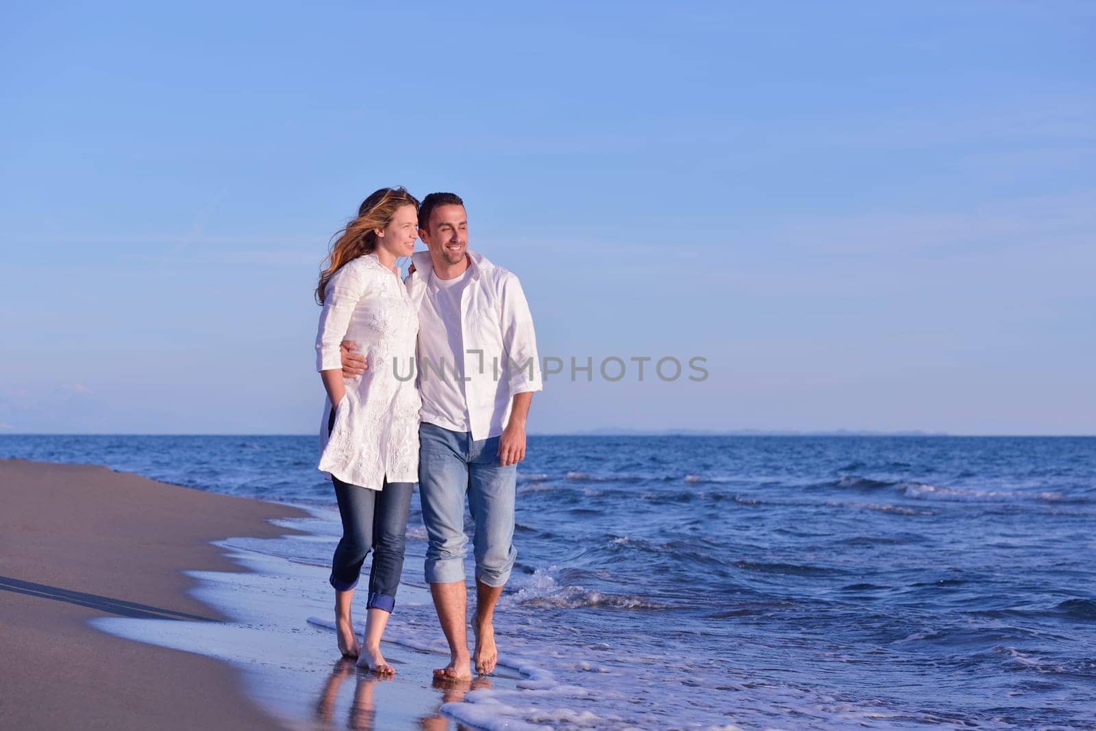 happy young romantic couple in love have fun on beautiful beach at beautiful summer day
