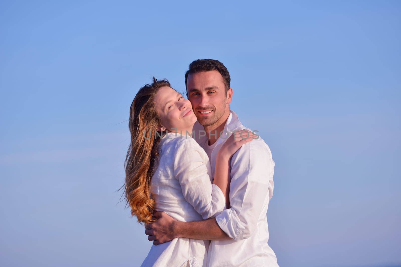 happy young romantic couple in love have fun on beautiful beach at beautiful summer day
