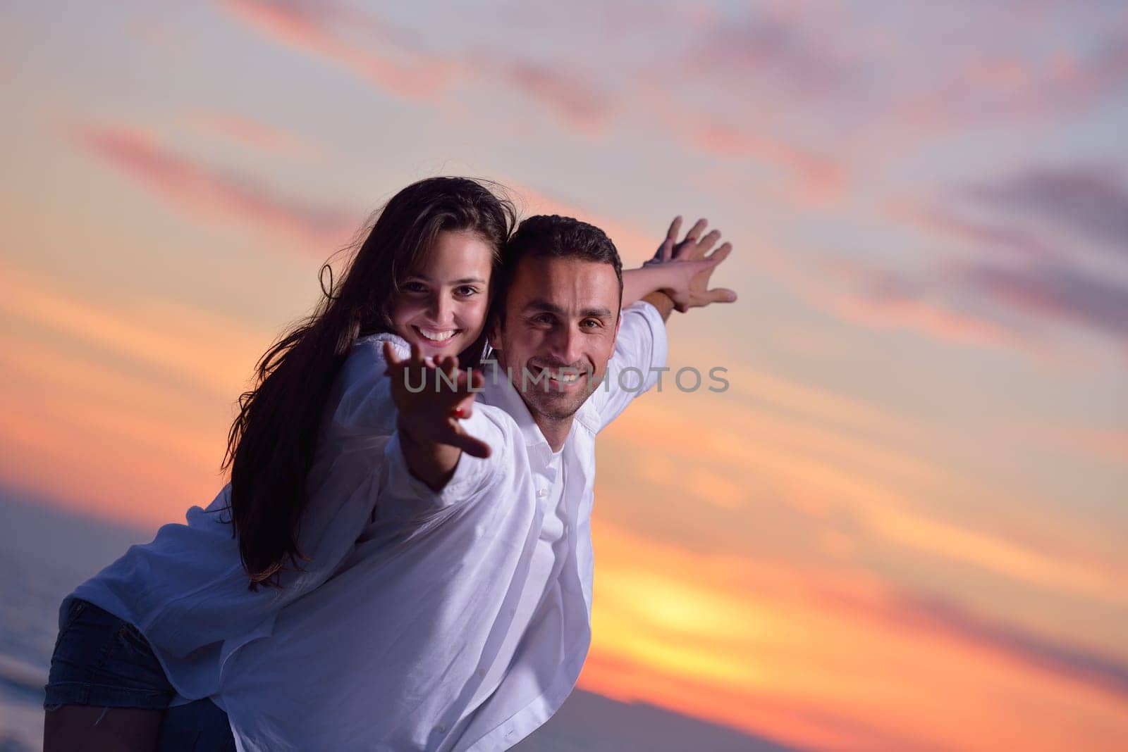happy young romantic couple in love have fun on beautiful beach at beautiful summer day