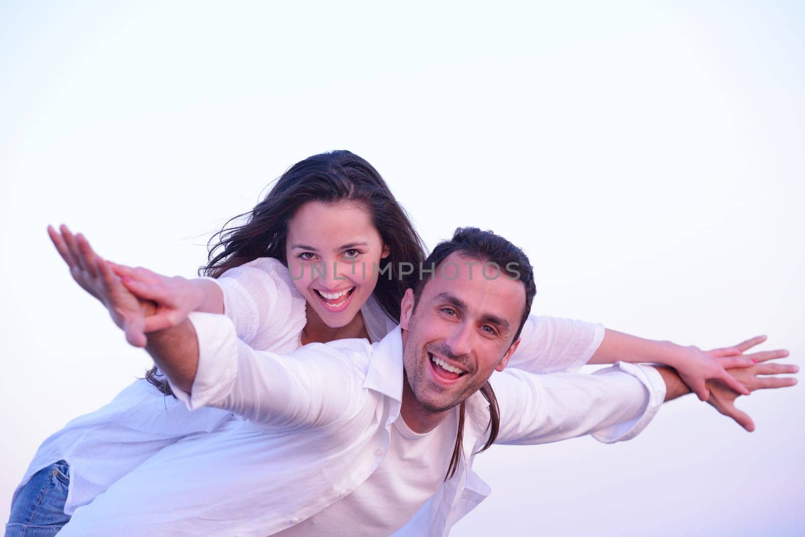 happy young romantic couple in love have fun on beautiful beach at beautiful summer day