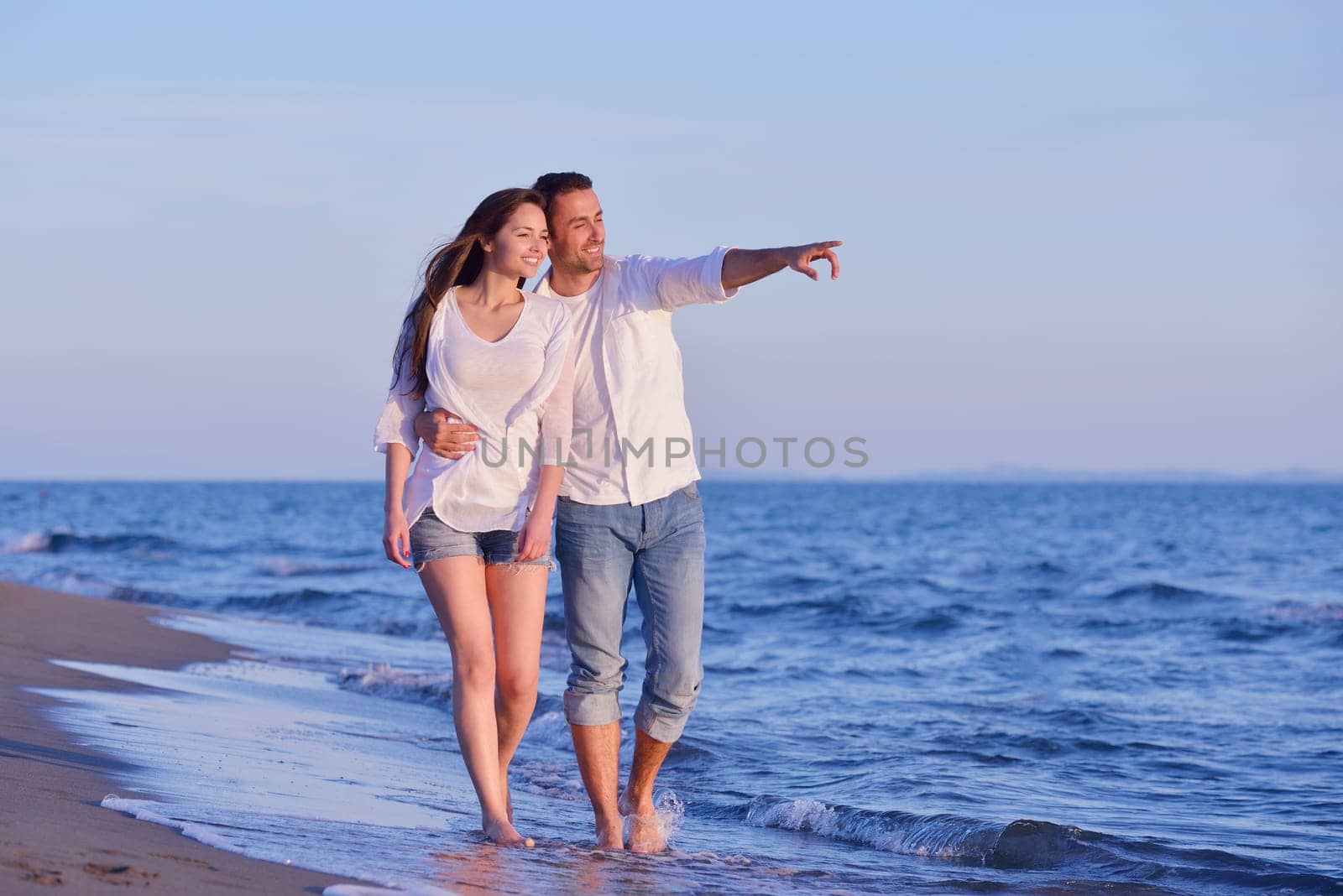 happy young romantic couple in love have fun on beautiful beach at beautiful summer day