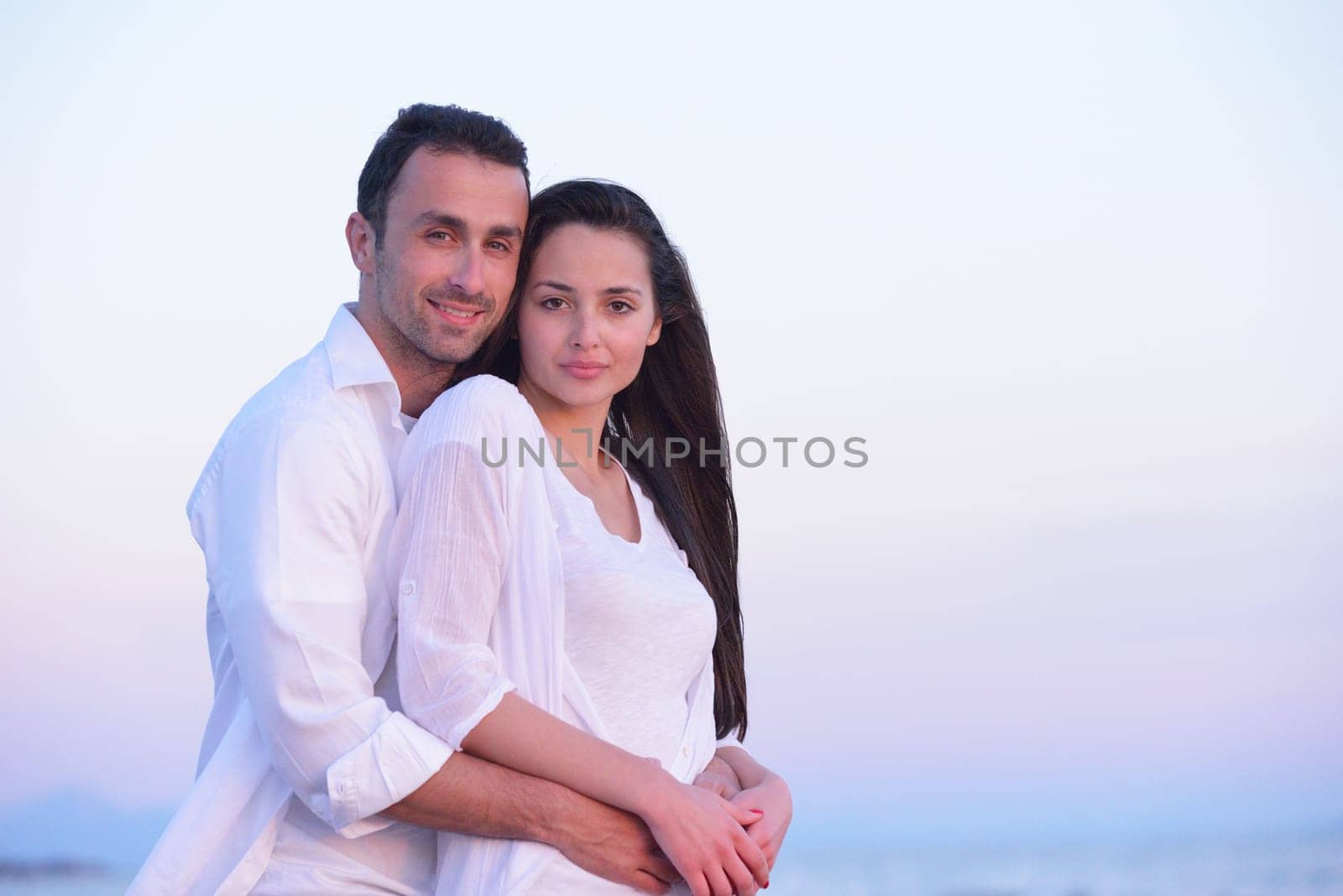 happy young romantic couple in love have fun on beautiful beach at beautiful summer day