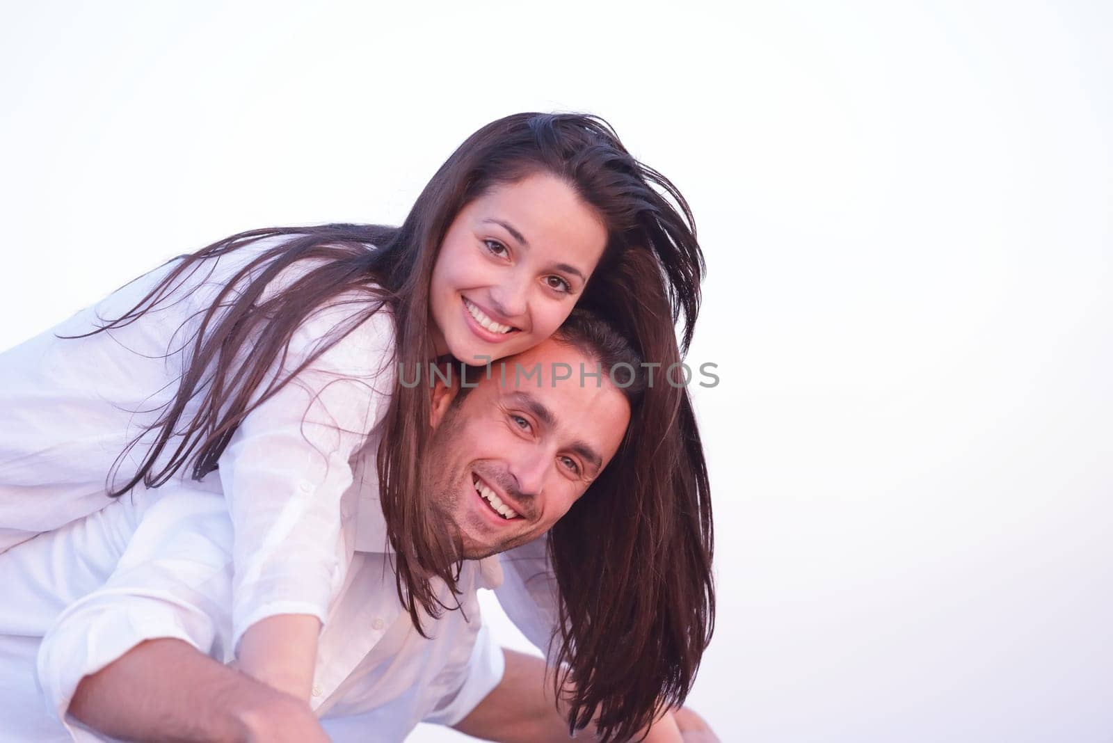 happy young romantic couple in love have fun on beautiful beach at beautiful summer day