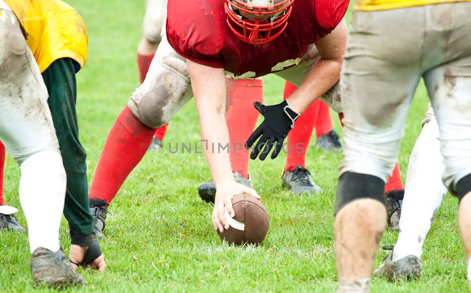 American football game in rain