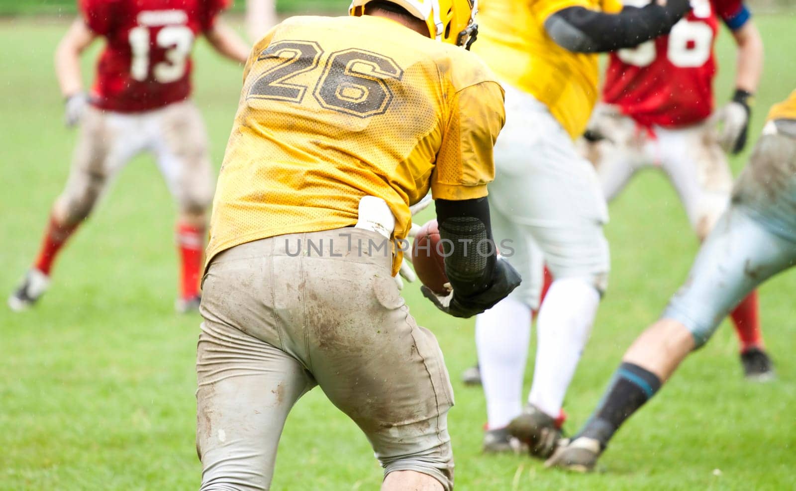 American football game in rain