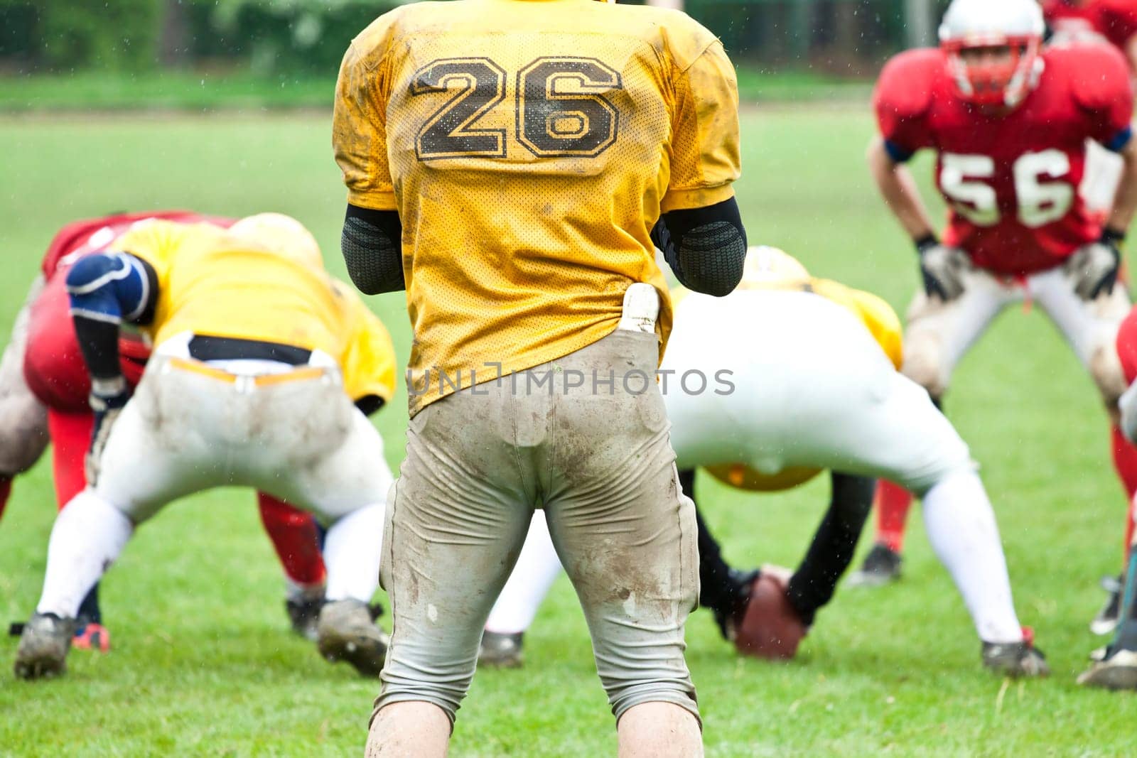 American football game in rain