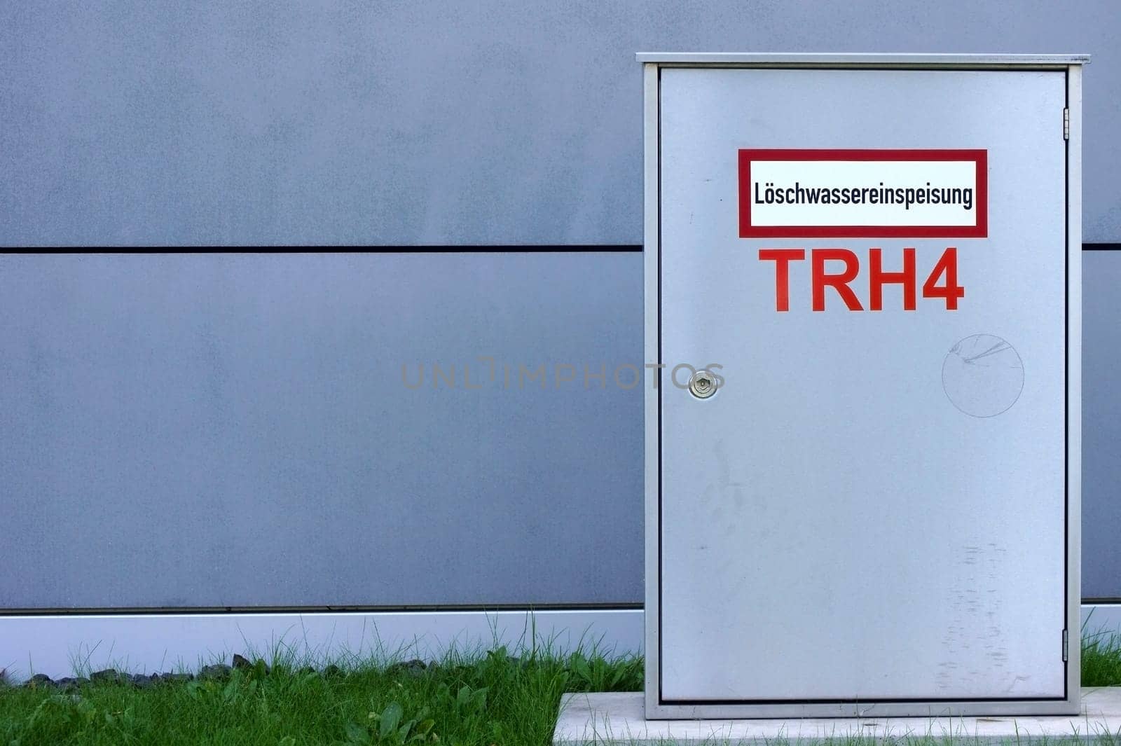 The photograph of a fire water supply and distribution box on a building.