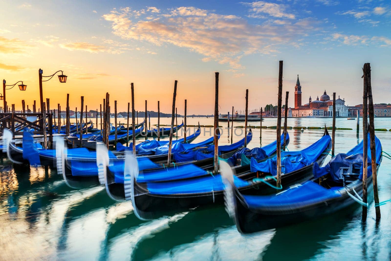 Gondolas moored by Saint Mark square with San Giorgio di Maggiore church in the background - Venice, Venezia, Italy, Europe