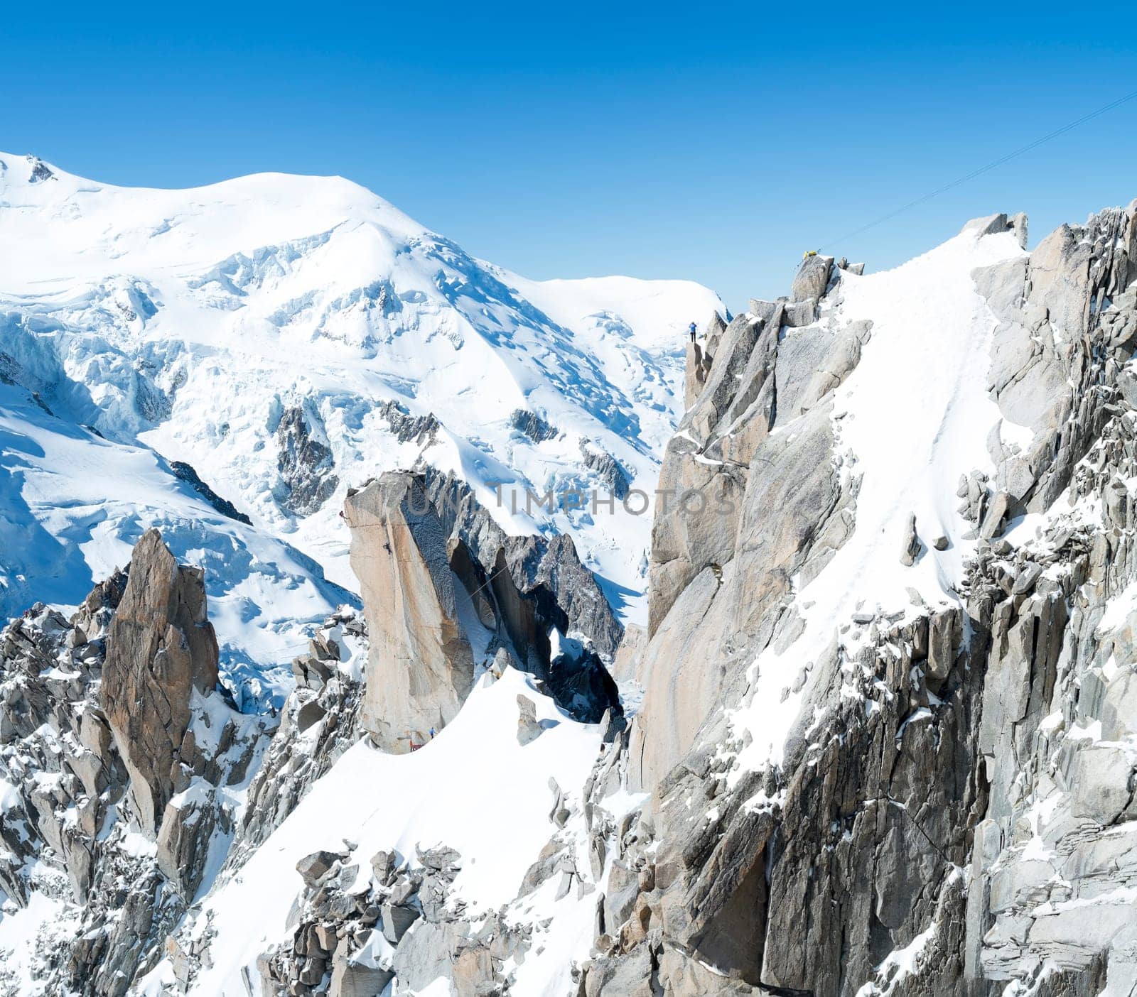 Panoramic composite of Mont Blanc mountain range, In Chamonix, France, with climbers on its rocks