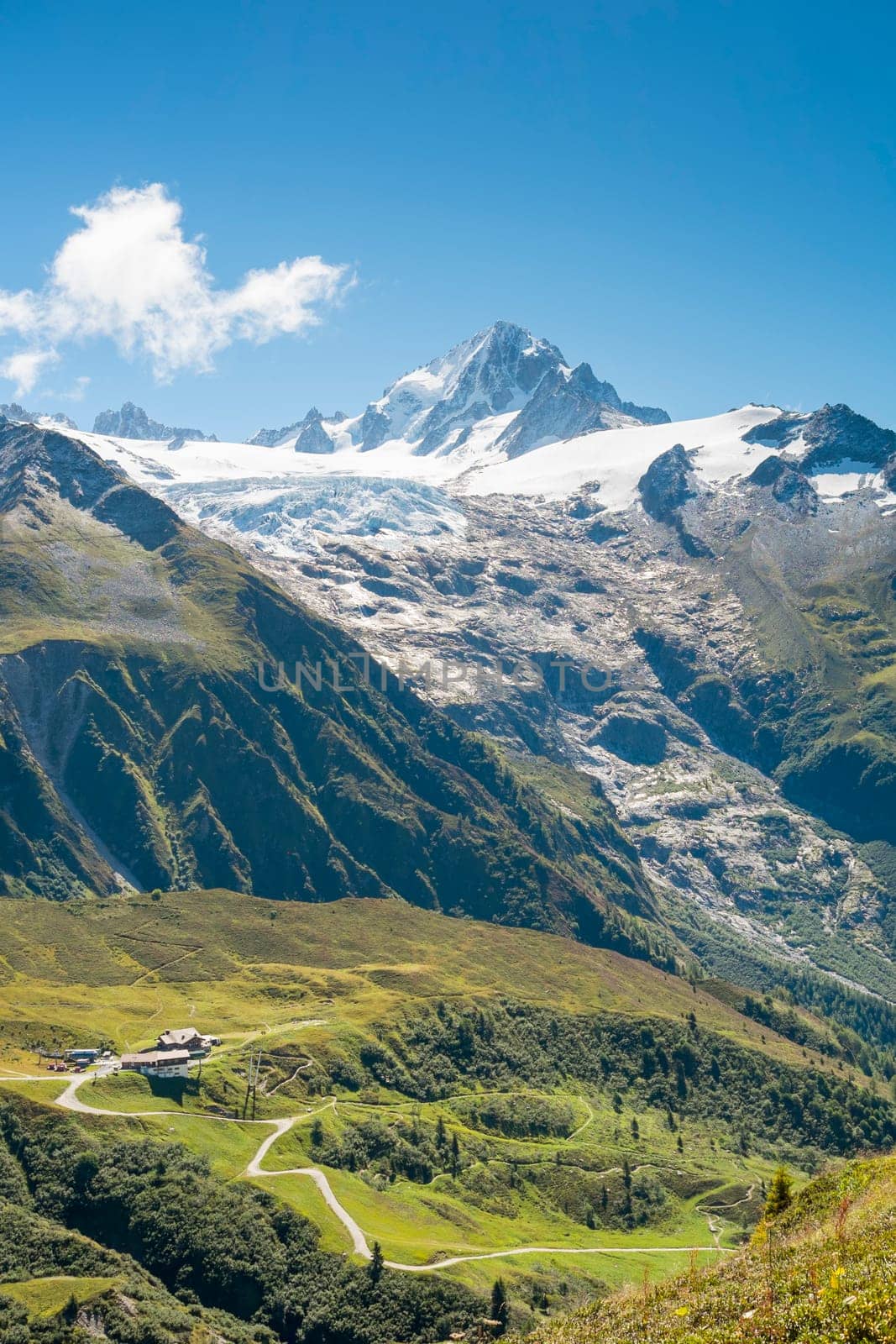 Chalets at the bottom of massive Tour Glaciers, in France.