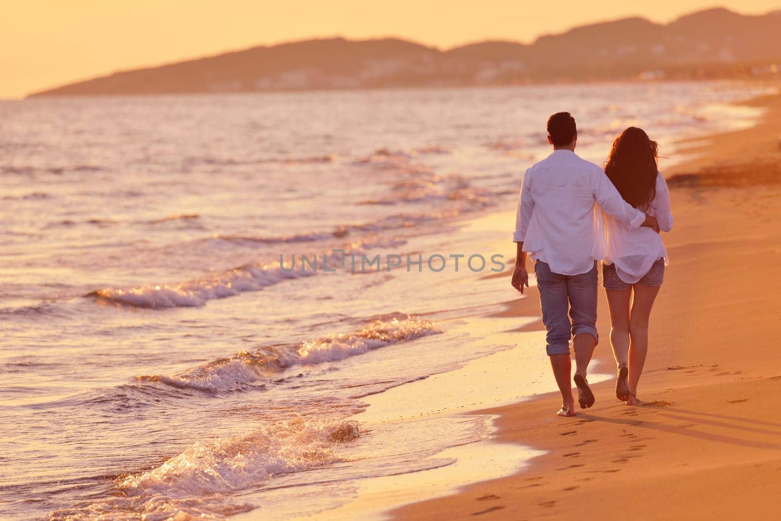 happy young romantic couple in love have fun on beautiful beach at beautiful summer day