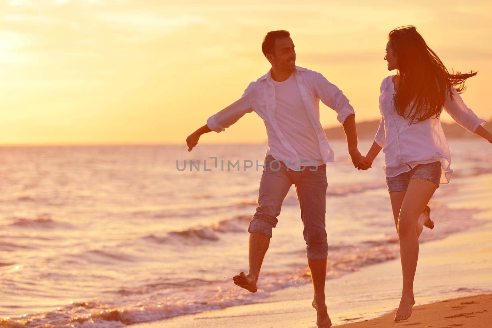 happy young romantic couple in love have fun on beautiful beach at beautiful summer day