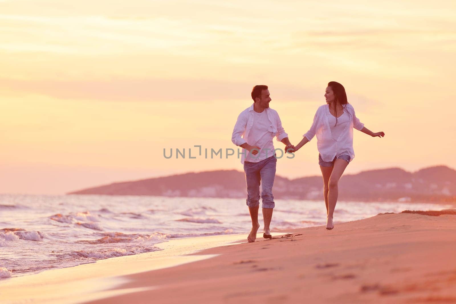 happy young romantic couple in love have fun on beautiful beach at beautiful summer day