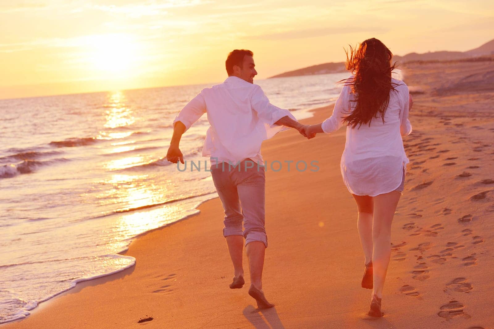 happy young romantic couple in love have fun on beautiful beach at beautiful summer day