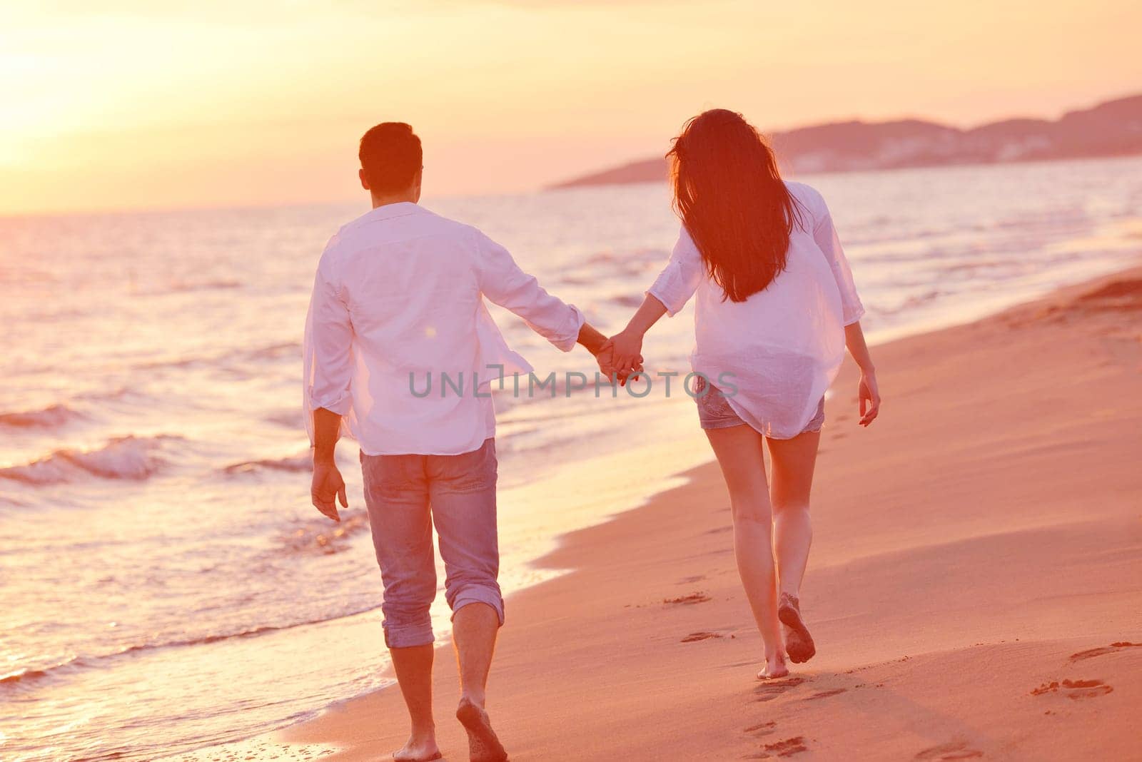 happy young romantic couple in love have fun on beautiful beach at beautiful summer day