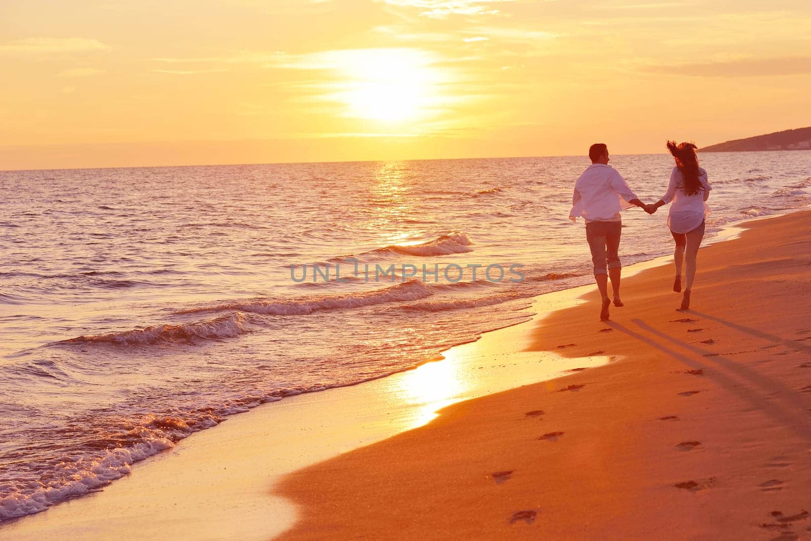 happy young romantic couple in love have fun on beautiful beach at beautiful summer day