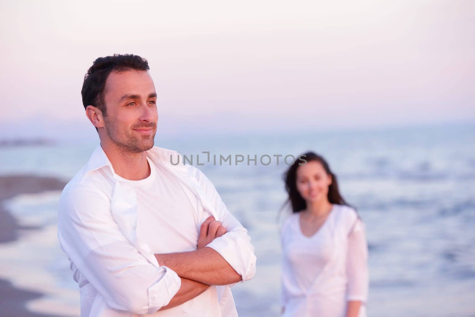 happy young romantic couple in love have fun on beautiful beach at beautiful summer day