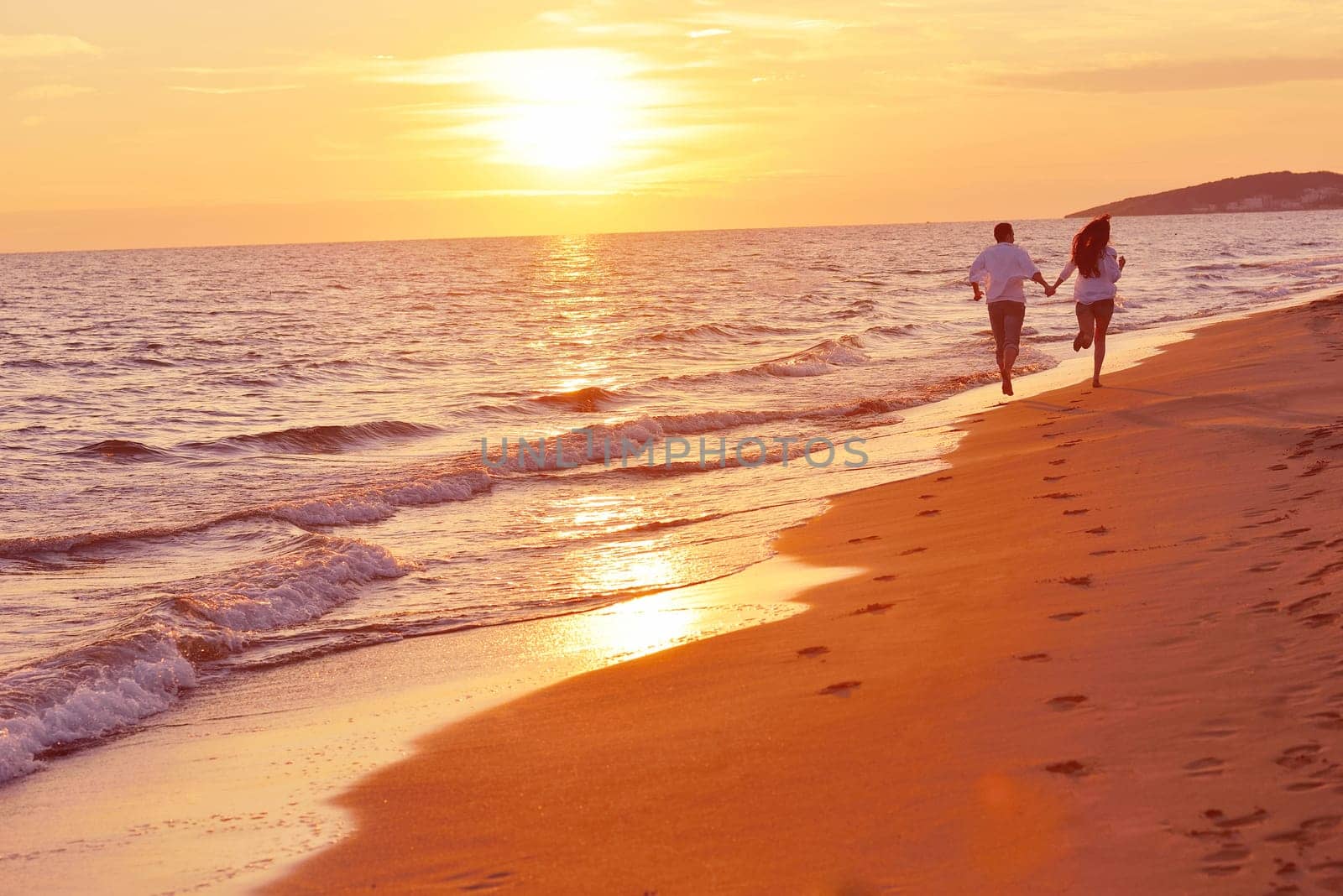 happy young romantic couple in love have fun on beautiful beach at beautiful summer day