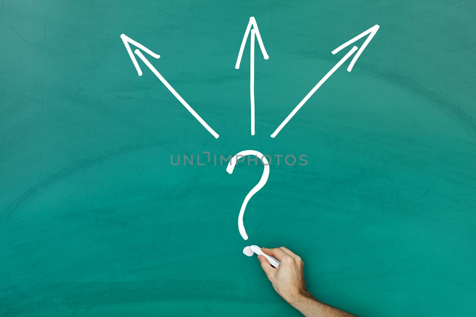 Hand holding chalk writing direction choice concept on green blackboard