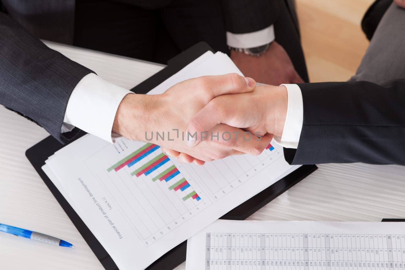 Close Up Of Two Business People Shaking Hands