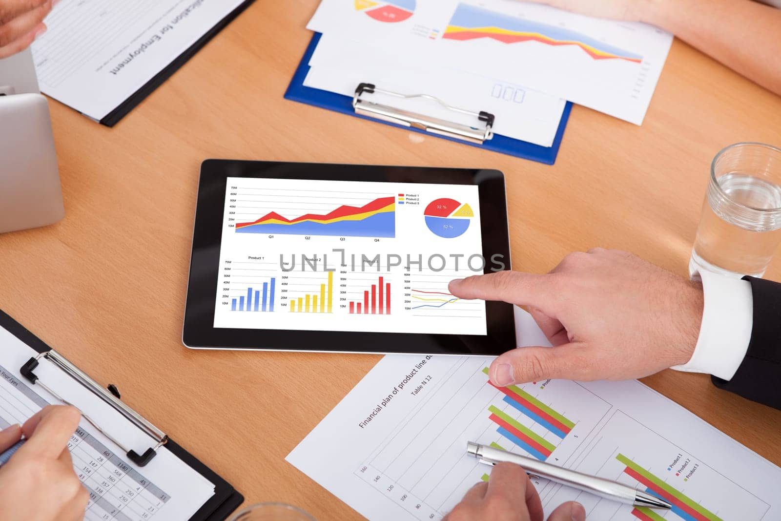 Close-up Of A Businesspeople Pointing Together On Digital Tablet