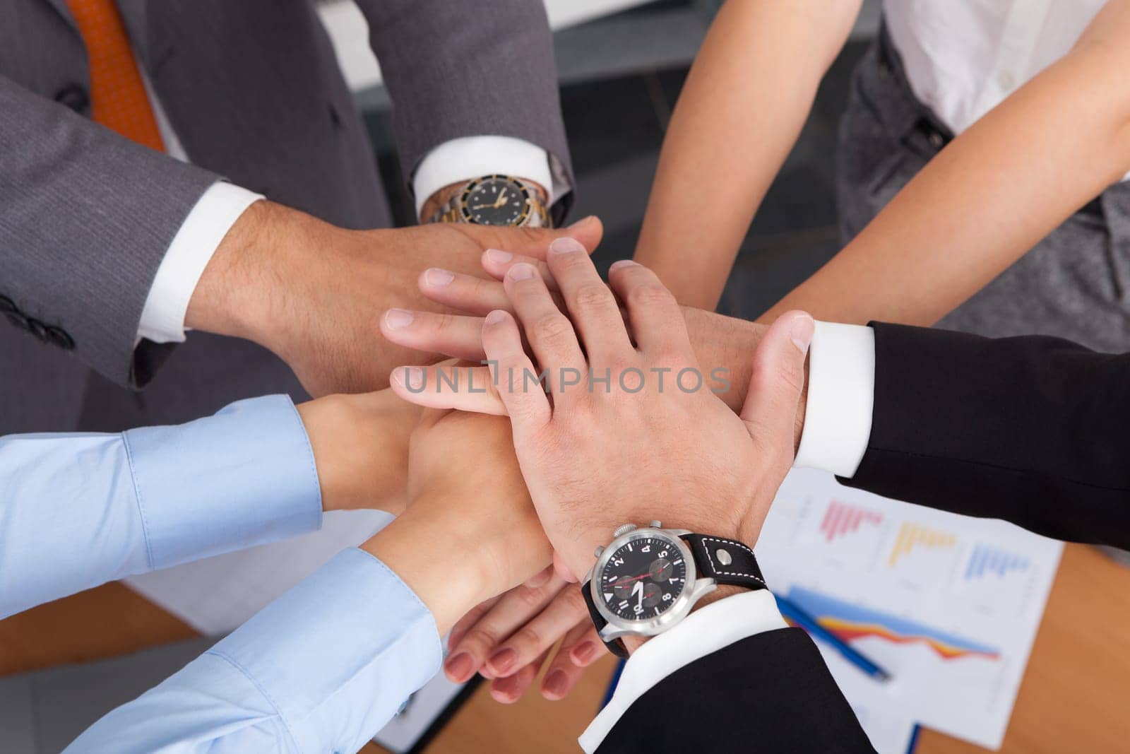 High Angle View Of Businesspeople Stacking Their Hands Together