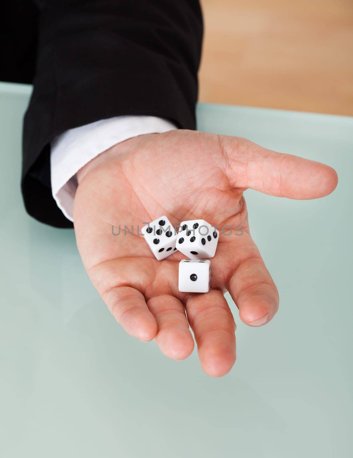 Close up of businessman in suit holding dice