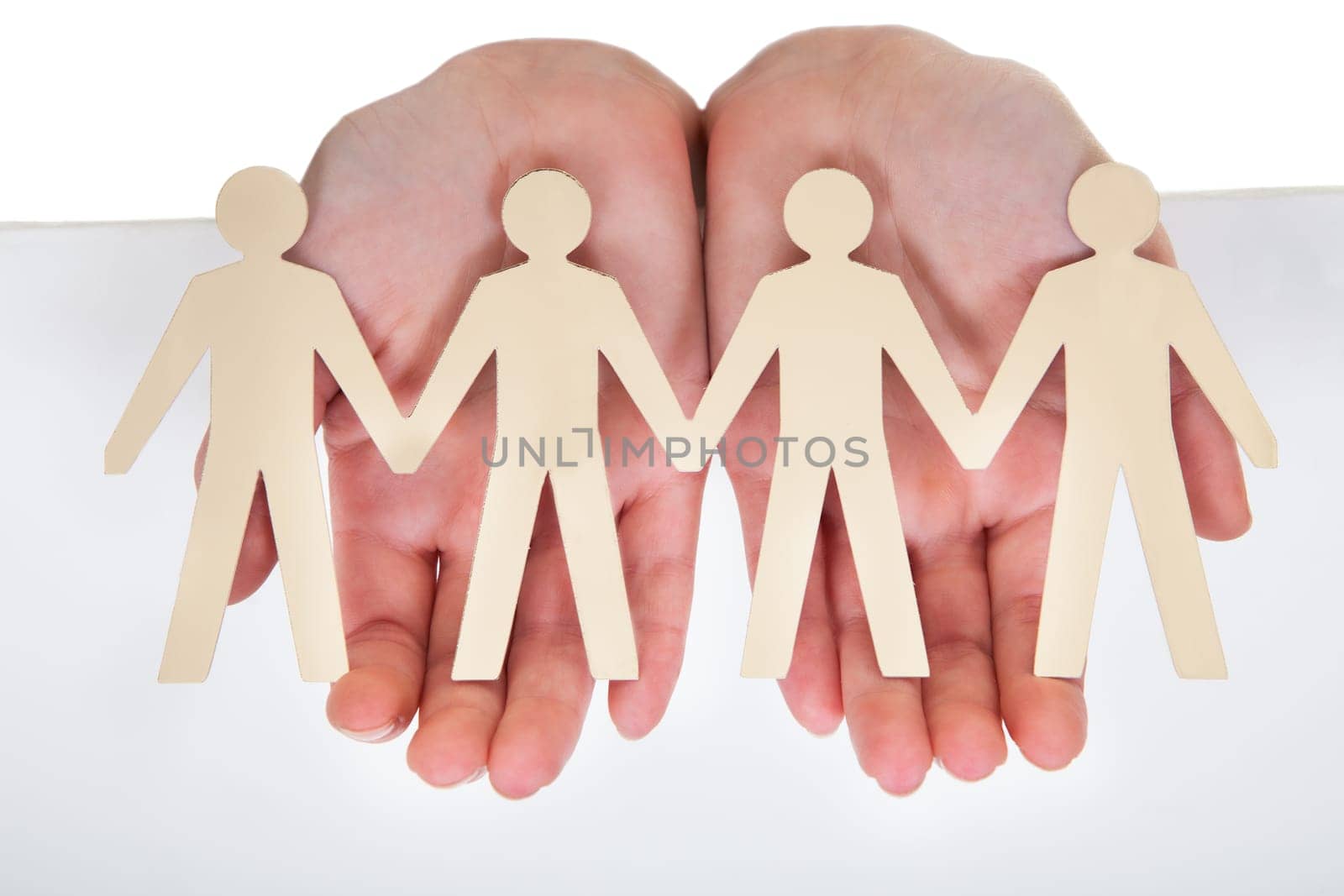 Close-up Of Male Hand Holding Human Figure Cutout
