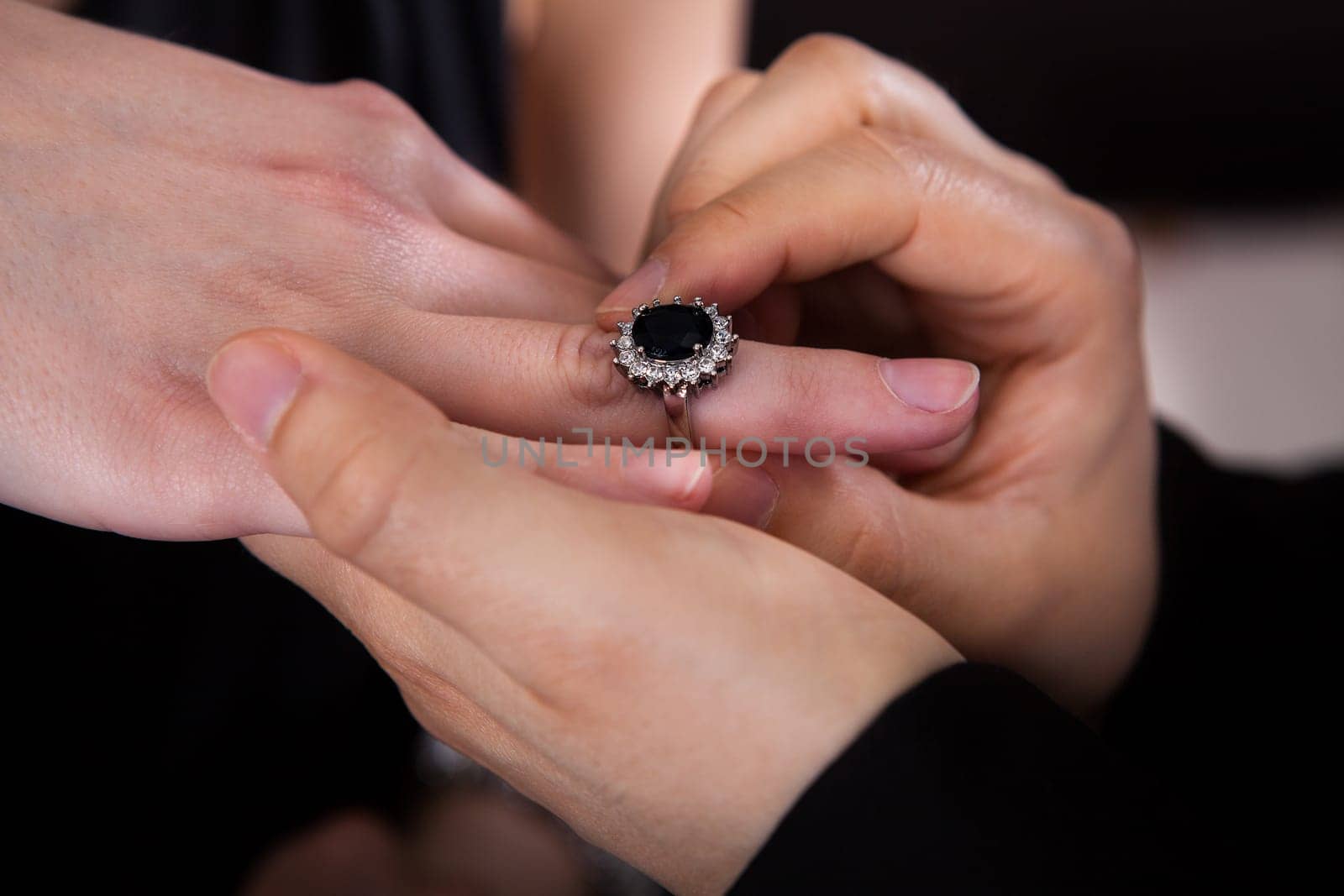 Close up of man hand inserting ring in woman finger