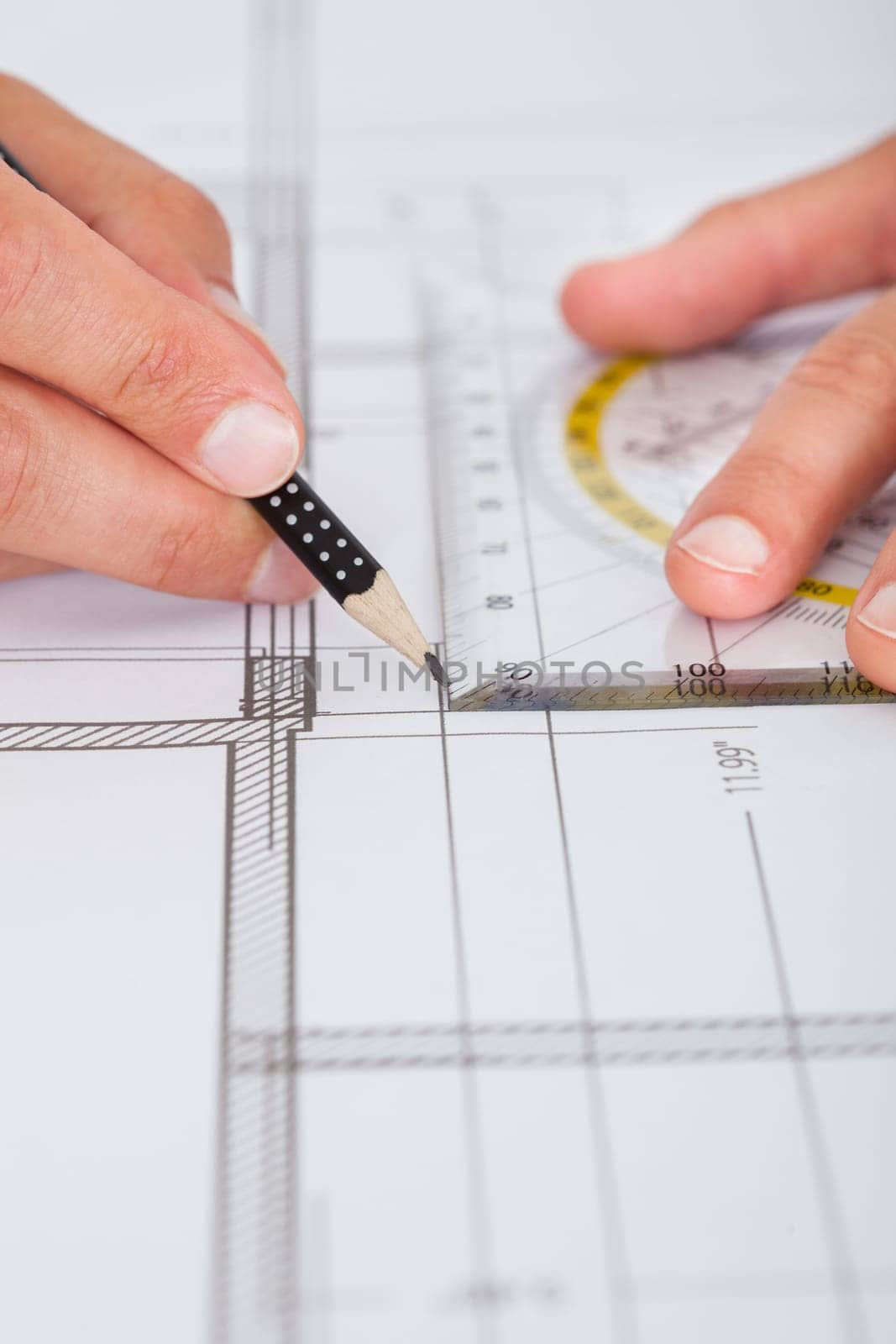 Close-up Of Person's Hand Drawing Plan On Blue Print