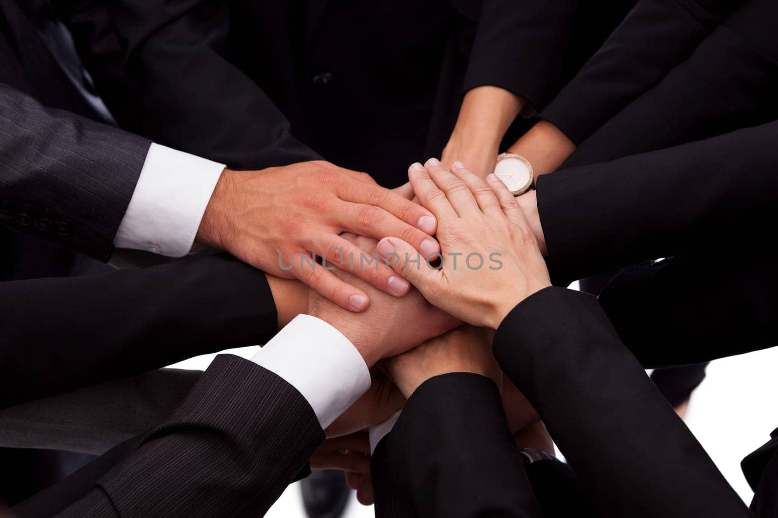 High angle view of a diverse group of people in a business team with their hands one on top of the other