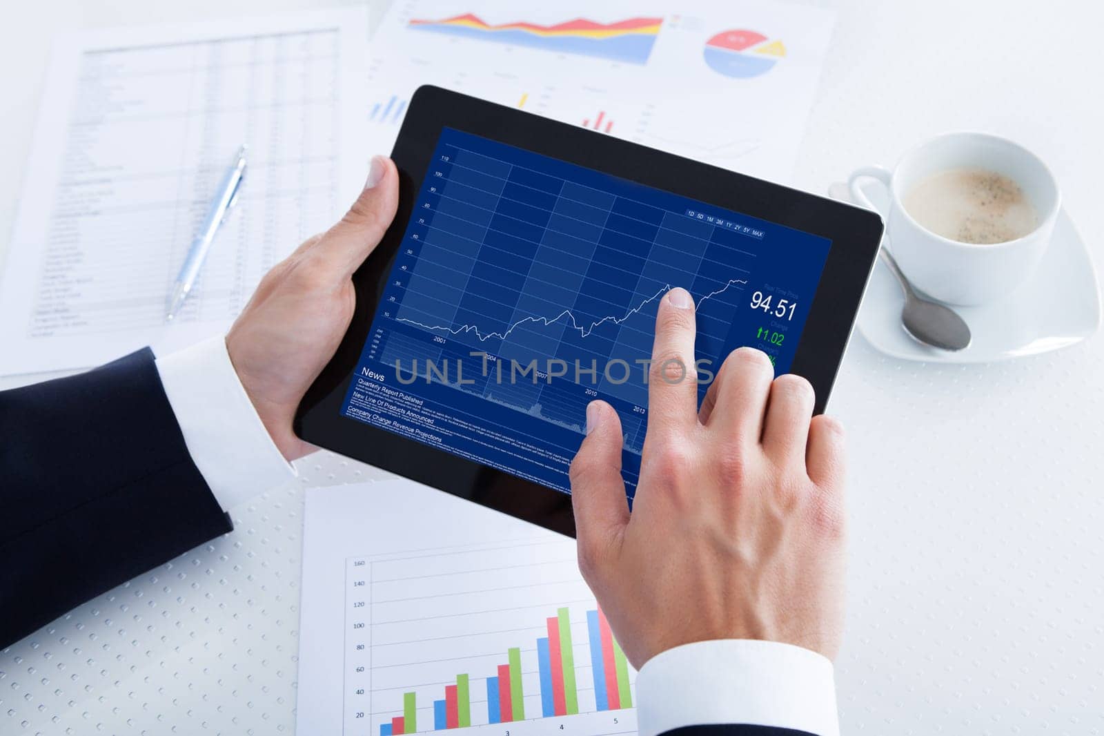 Businessman Analyzing Graph On Digital Tablet In Office